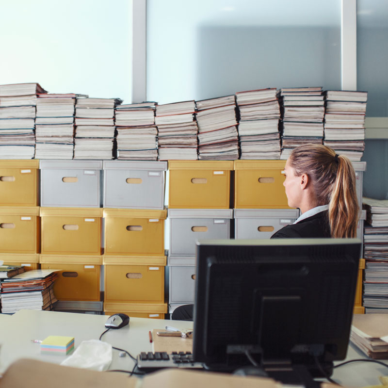 Messy office with stacks of files and documents