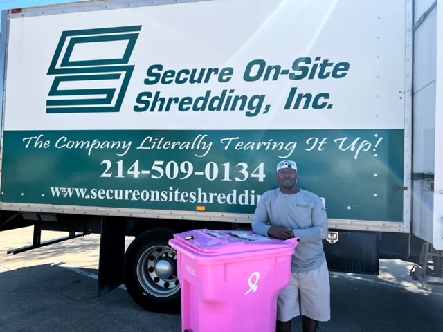 Susan G Komen pink recycle bin and employee in front of Secure On-Site Shredding Truck